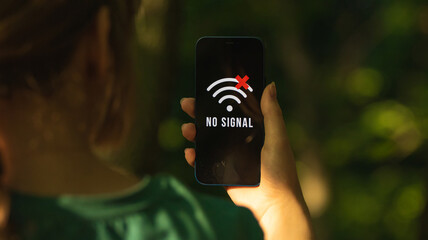 Mobile phone without signal, no service screen, girl in the forest with smartphone, searching for the help