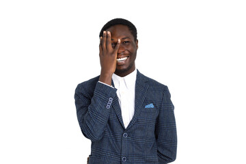 Smiling young successful african in business clothes looks through his fingers and standing on isolated white background