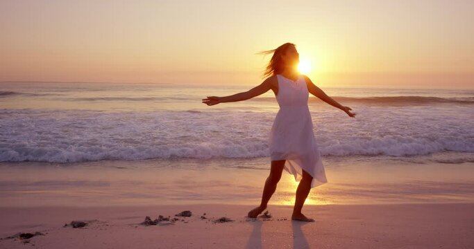 Free happy woman spinning arms outstretched enjoying nature dancing on beach at sunset slow motion RED DRAGON
