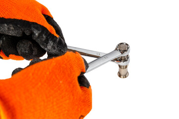 Naklejka premium worker's hands holding two wrenches and tightening a bolt on a white background.