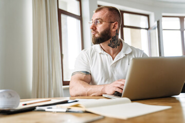Calm mid aged white man working studying