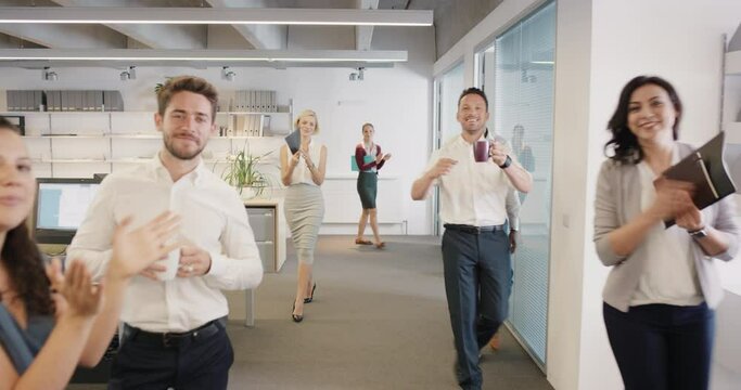 Congratulations businessman receiving praise as team members clap in applause celebrating victory on return to office slow motion walk POV shot concept series