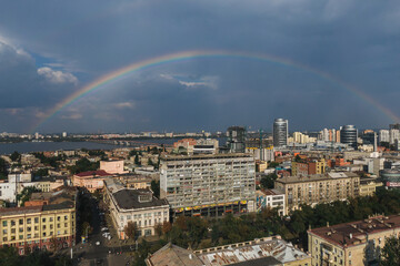 Beautiful double rainbow in the city after the rain. Photo from the drone. Rainbow against the blue sky