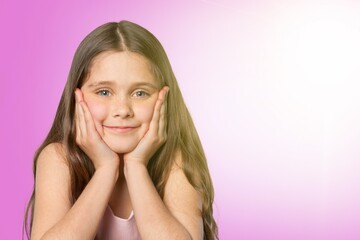 Cute little girl posing on a background