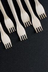 wooden forks on a dark background