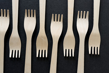 wooden forks arranged on a dark background