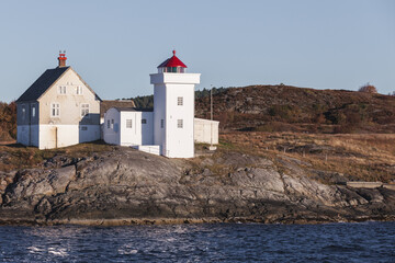 Fototapeta na wymiar Terningen Lighthouse. White tower with red top