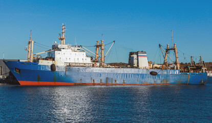 Trawler ship with blue hull is moored in Norwegian port