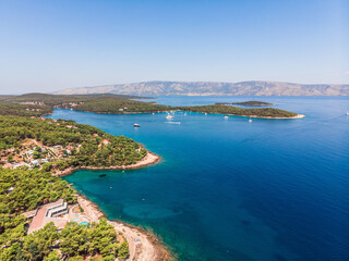 Naklejka na ściany i meble Drone shot on boat trips to the nearby Paklinsky Islands. Secluded beaches and coves in Croatian island of Hvar. Dubovitsa, and lavender fields frame from drone. Drone shot on Croatian island
