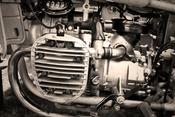Close up of engine of antique motorcycle, black and white