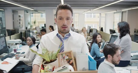 Businessman getting fired carrying box of personal belongings being made redundant in recession sad worried failure