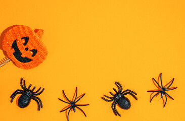 orange halloween background. black spiders and pumpkin