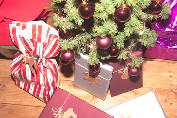 Christmas mood with gifts, on wooden background and tree with red balls