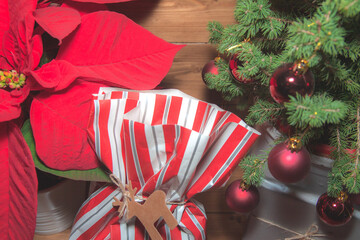 Christmas mood with gifts, on wooden background and tree with red balls