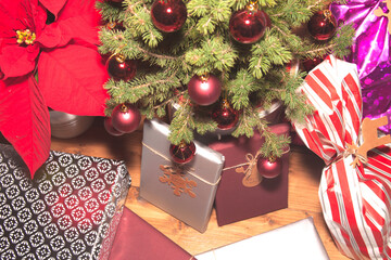 Christmas mood with gifts, on wooden background and tree with red balls