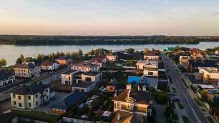 Fototapeta premium Aerialphoto suburbs of big city. Country houses, forests, lakeshore. Citylife concept.