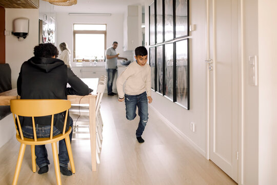 Autistic boy running in living room