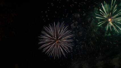 Beautiful colorful holiday fireworks on the black sky background, long exposure. Festive concept.