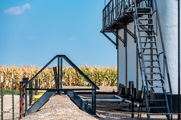 Ramp and stairs over a secondary containment dike for chemical oil storage confined space