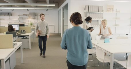 Busy activity in diverse business office with business people working multi tasking in workplace discussing growth ideas and networking