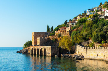 Naklejka premium Landscape of an ancient shipyard near the Kyzyl Kule tower in Alanya, Antalya region, Turkey at sunrise.