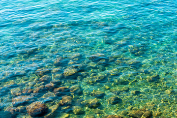Fototapeta na wymiar Mediterranean Sea in Turkey. View of the water and stones.