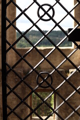 view through the bars through the window on the old castle