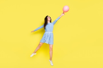 Profile photo of dream lady jump hold fly air balloon wear dotted blue mini dress isolated yellow color background