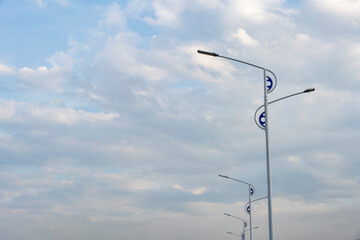 The city street lights are under the blue sky.