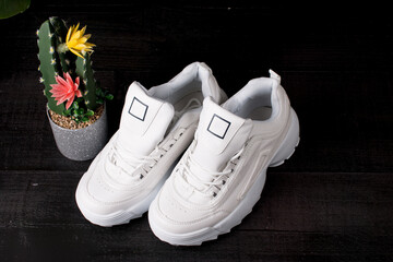 women's white sneakers for sports. On a black background