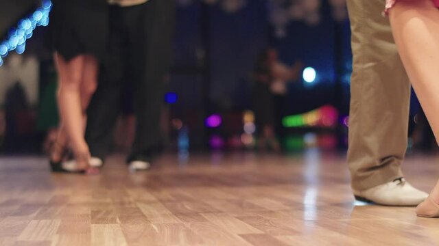 Tango dancers feet while dancing close-up