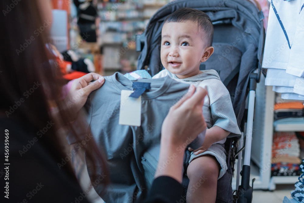 Canvas Prints mother are trying to fit the product on her son before purchase it