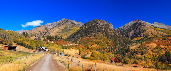 Panoramic view of Colorful fall foliage on slopes of San Juan mountains along Last Dollar Road in rural Colorado - obrazy, fototapety, plakaty