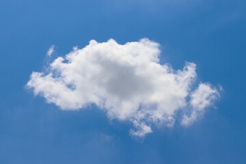 The fluffy white cloud in the blue sky.