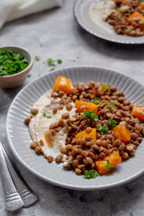 Vegan healthy food. Lentils and butternut squash with houmus and green herbs, clean eating concept