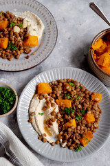 Vegan healthy food. Lentils and butternut squash with houmus and green herbs, clean eating concept