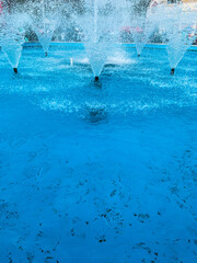 Closeup of decorative water fountains in pool. 