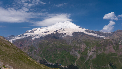 Volcano Elbrus. Landscape view in the south-east of mount from Cheget mount. Kabardino-Balkaria region, Russia.
