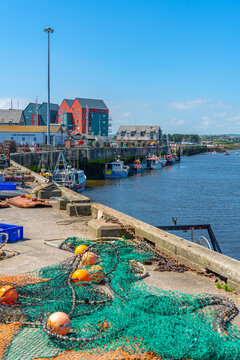 View of fishing nets on quayside and River Coquet at Amble, Morpeth, Northumberland