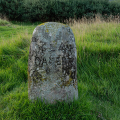 Culloden battlefield in Scotland. Isolated headstone for Clan Cameron with background of grass and other greenery.