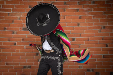 Mexican charro dancer with sombrero and multicolored serape from jalisco mexico with mariachi music