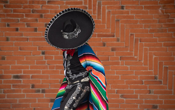 Mexican charro dancer with sombrero and multicolored serape from jalisco mexico with mariachi music