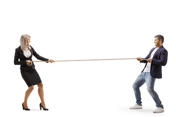 Full length profile shot of a businesswoman and a casual man pulling a rope