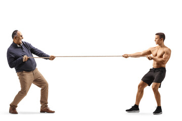 Full length profile shot of a mature man and a strong bodybuilder pulling a rope