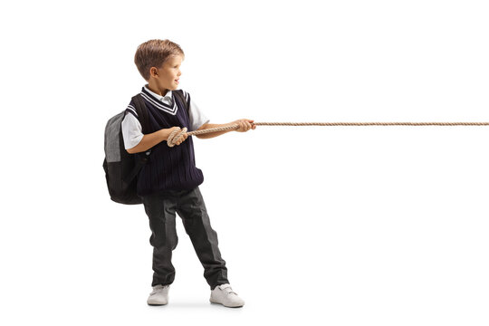 Full length profile shot of a little schoolboy pulling a rope