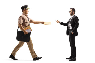 Full length profile shot of a mailman giving a letter to a businessman