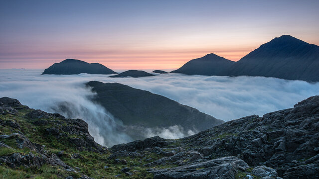 Sunrise behind Bla Bheinn and Marsco with an early morning inversion filling Glen Sligachan and flowing over the minor tops, Isle of Skye