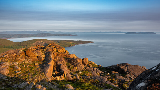 Looking down on the village of Elgol and the Isle of Eigg from the summit of Sgurr na Stri at sunset, Isle of Skye