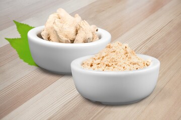 Finger root powder in a bowl with fresh leaves