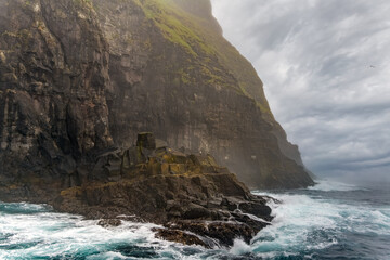 Stunning boat ride among the  steep bird cliffs, caves, narrow straits and grottoes of Vestmanna, Streymoy island, Faroe Islands